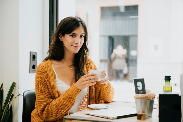 Woman in cafe looking at camera