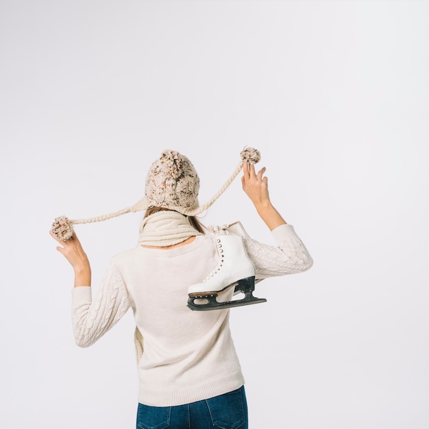 Free Photo woman in cap holding skates