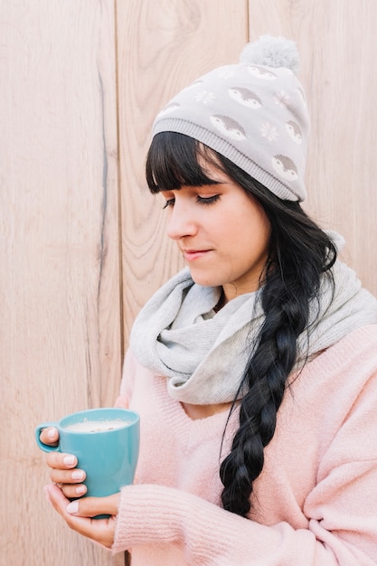 Free photo woman in cap with coffee cup