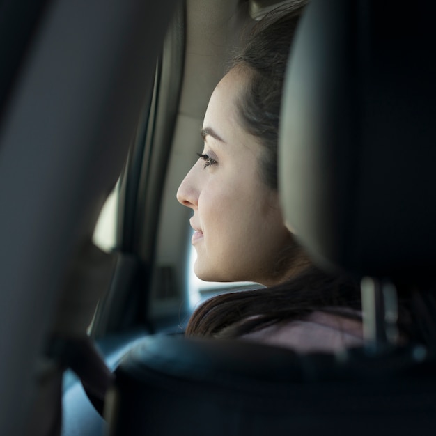 Woman in the car from behind view