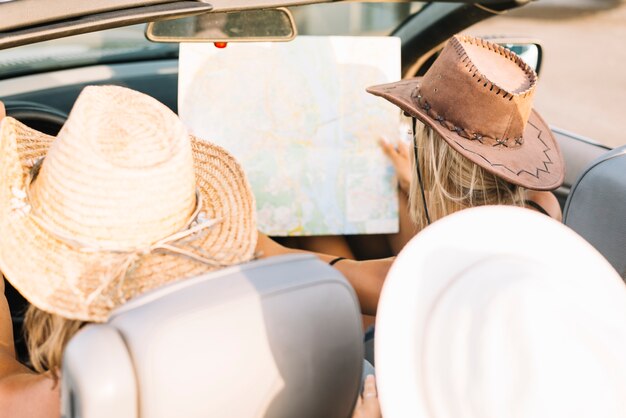 Woman in car looking at map