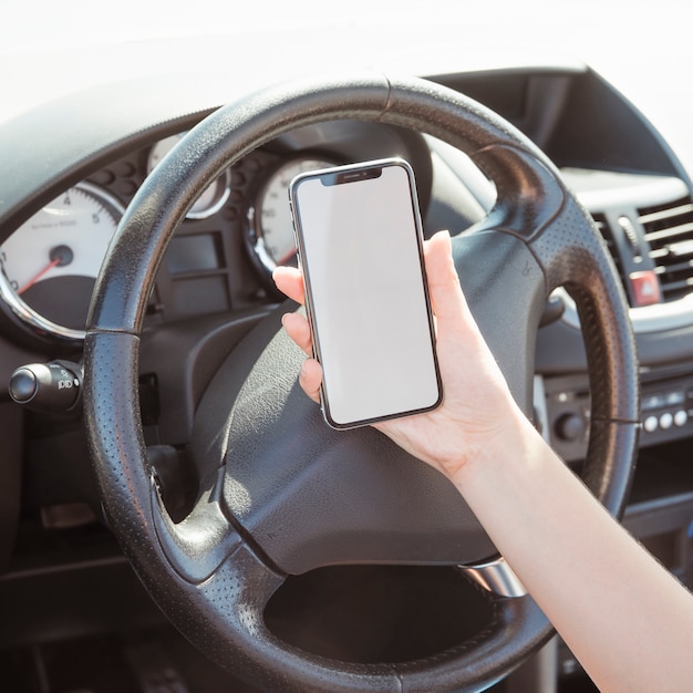 Woman in car looking at smartphone template