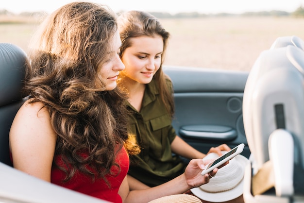 Woman in car using phone