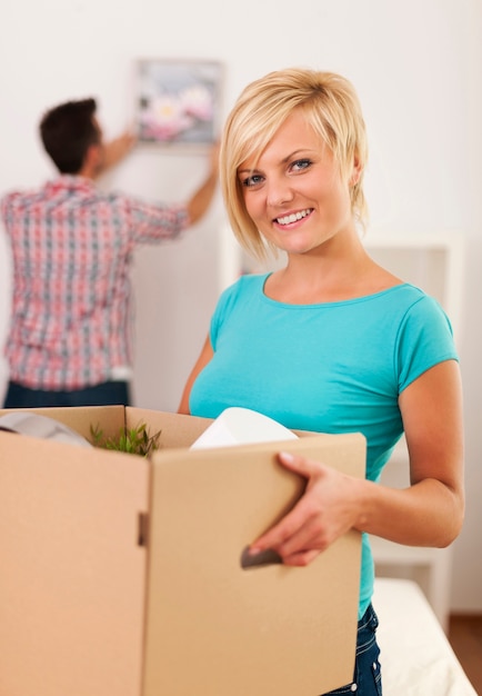 Woman carrying box with items for a new apartment