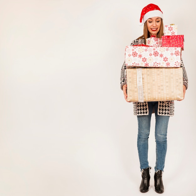 Free photo woman carrying gift boxes