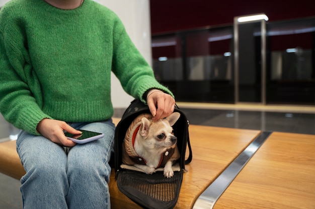 Free Photo woman carrying her pet in the subway