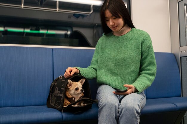 Woman carrying her pet in the subway