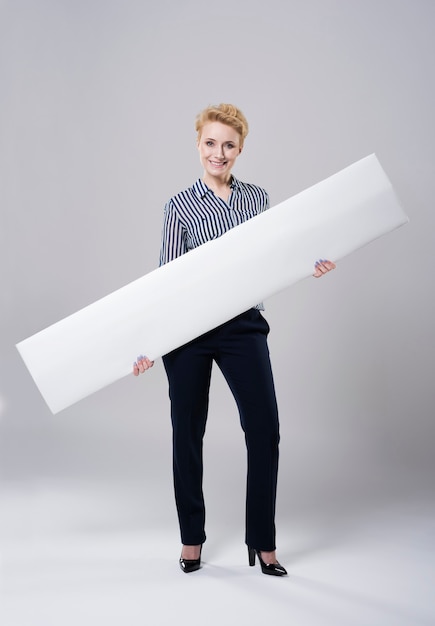 Woman carrying a long white placard