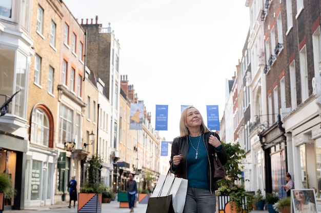 Woman carrying shopping bags medium shot