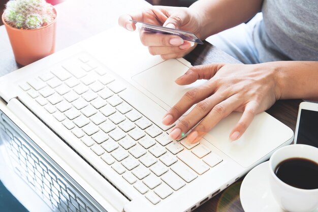 Woman in casual clothing using laptop with credit card, Online shopping at home