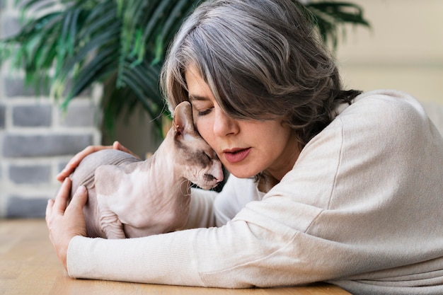 Free Photo woman and cat being affectionate medium shot