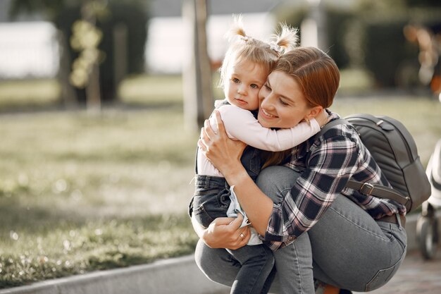 Woman in a cell shirt. Family on a sunlight background.