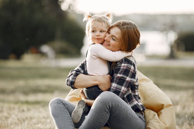 Woman in a cell shirt. Family on a sunlight background.