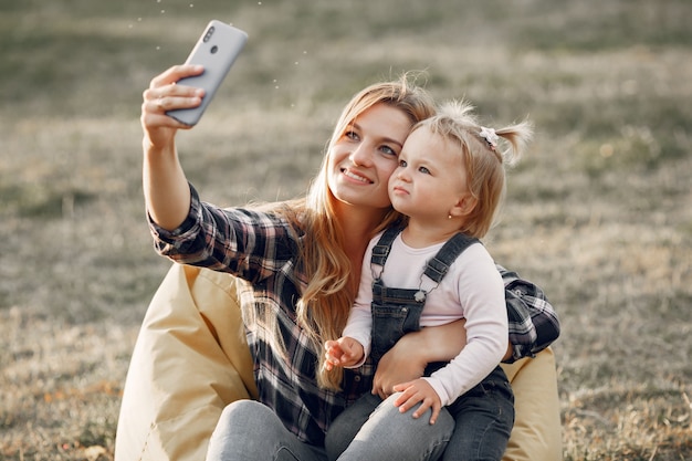 Woman in a cell shirt. Family on a sunlight background.