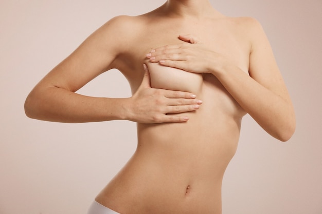 Woman checking her breast for breast cancer