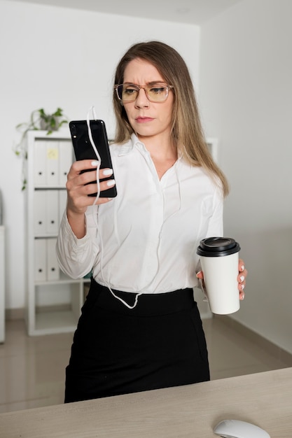 Woman checking her phone at work