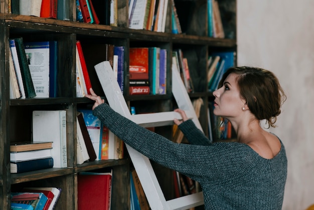 Free Photo woman choosing book from shelf