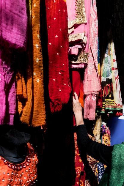 Free photo woman choosing colorful sari in the market