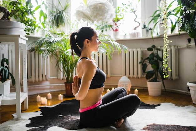 Woman clasping hands behind back during meditation