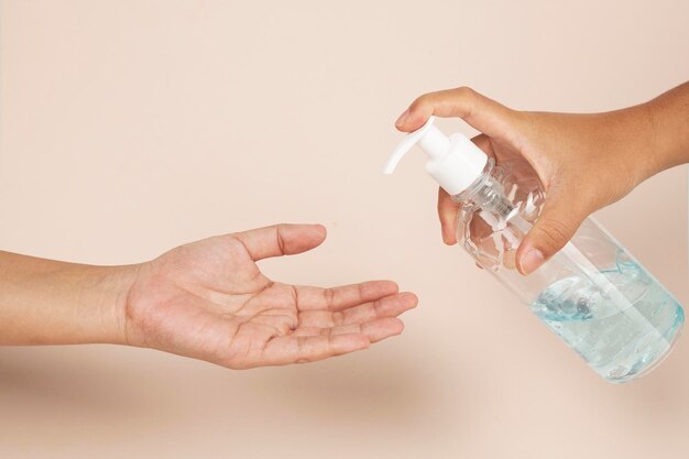 Woman cleaning hands with a hand sanitizer gel to prevent coronavirus contamination