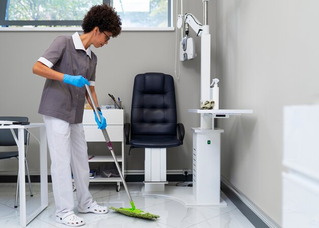 Woman cleaning ophthalmologist's office