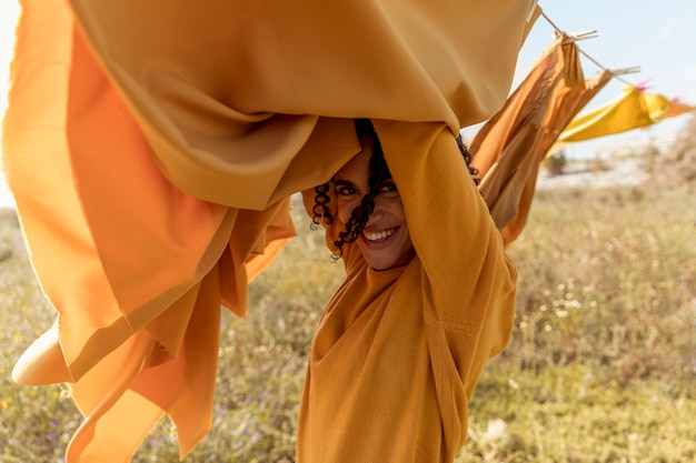 Free photo woman next to clothesline in fields