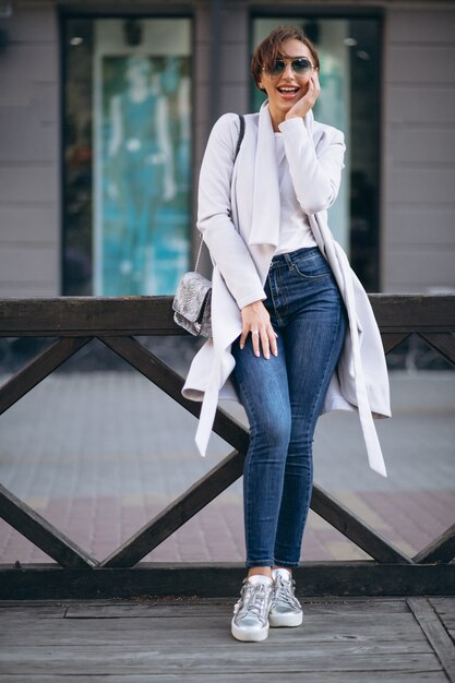 Woman in coat outside th street