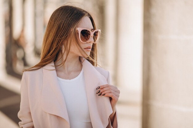 Woman in coat walking in the street