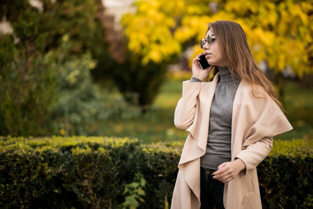 Woman in coat with phone