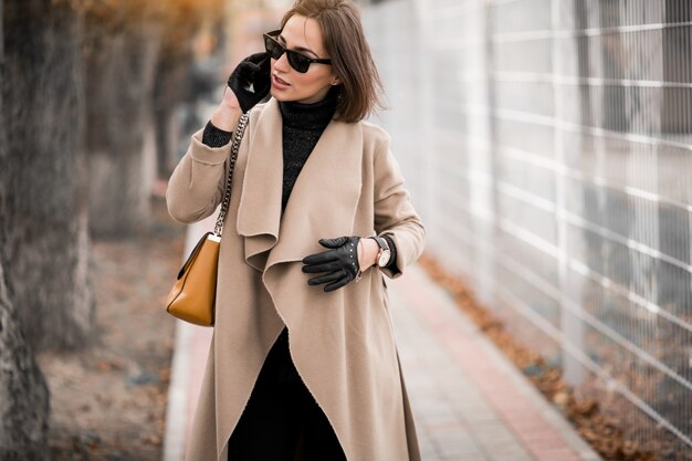 Woman in coat with phone