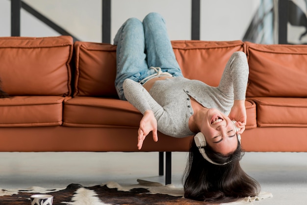 Woman on couch with headphones