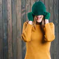 Free photo woman covering face with cap