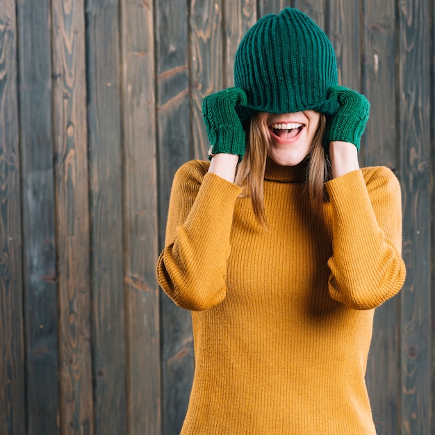 Free Photo woman covering face with cap