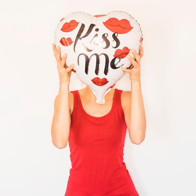 Free photo woman covering face with heart balloon