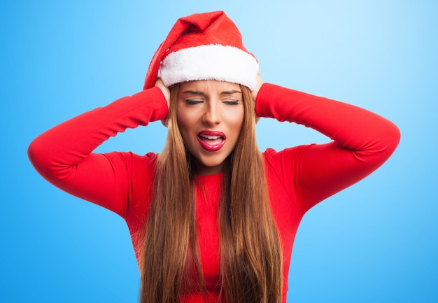 Free photo woman covering her ears in a blue background