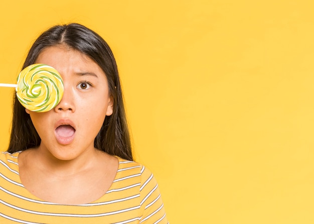 Woman covering her eye and being surprised