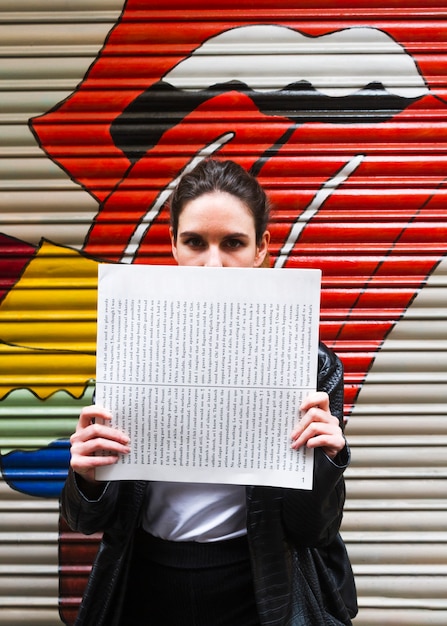 Woman covering her face with paper 