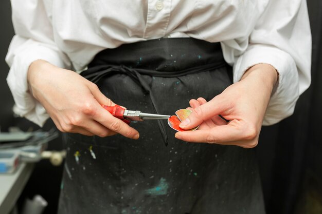 Woman crafting a colorful abstract object