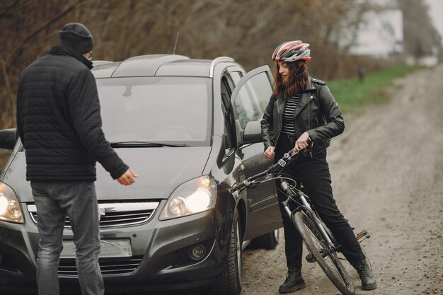 The woman crashed into the car. Girl in a helmet. People quarrel over the accident.