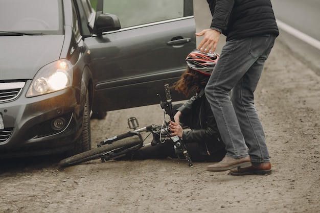 Free Photo the woman crashed into the car. girl in a helmet.