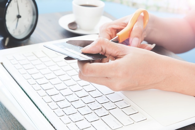 Woman cutting credit card, Online shopping concept