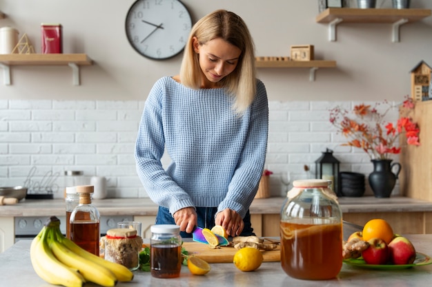 Free photo woman cutting ingredients front view