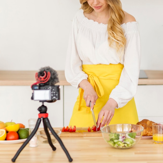 Woman cutting vegetable in kitchen