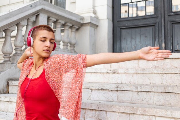 Woman dancing outdoors medium shot