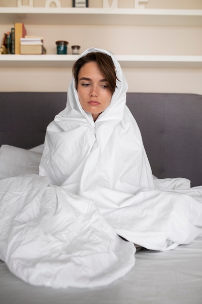 Woman dealing with anxiety at home full shot