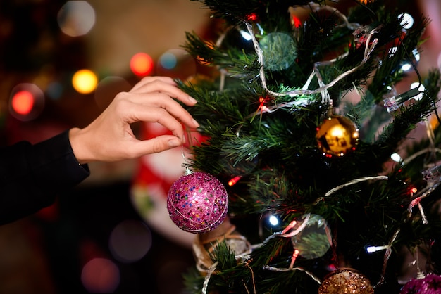 Woman decorating a christmas tree