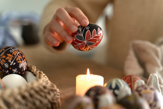 Free photo woman decorating easter eggs