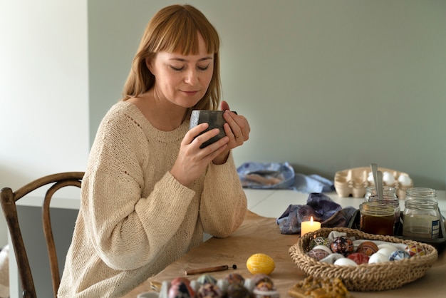 Woman decorating easter eggs