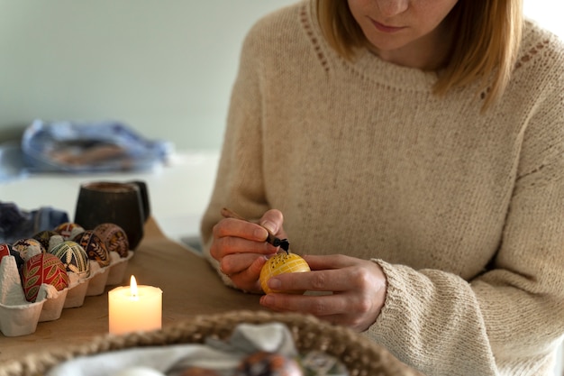 Woman decorating easter eggs