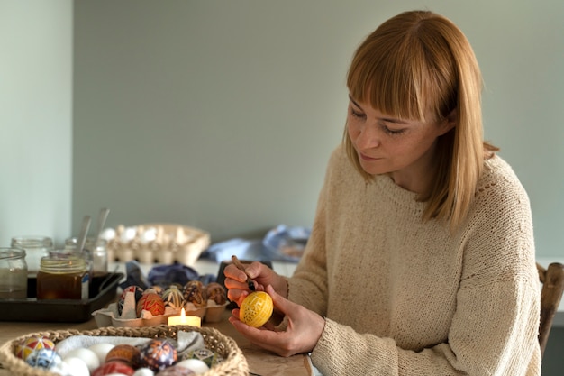 Woman decorating easter eggs